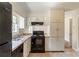 Kitchen featuring black appliances, ample cabinet space, and neutral countertops at 2877 Kensington Way, Rex, GA 30273