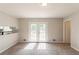 Spacious living room with neutral carpet and paint, featuring French doors at 2877 Kensington Way, Rex, GA 30273