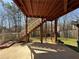 Concrete patio and stairs leading up to a wooden deck in the backyard with many trees providing lots of shade at 404 After Glow Smt, Canton, GA 30114