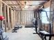 A home gym awaits in the basement with insulation, exposed ceiling and framing with various gym equipment at 404 After Glow Smt, Canton, GA 30114