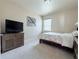 Comfortable bedroom with a floral comforter, TV and natural light at 404 After Glow Smt, Canton, GA 30114