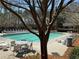 Community pool with sun loungers, tables, and a tranquil setting surrounded by mature trees at 404 After Glow Smt, Canton, GA 30114