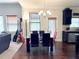Dining area with a modern glass table, stylish chairs, and a view into the living room at 404 After Glow Smt, Canton, GA 30114