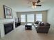 Inviting living room with a fireplace, plush carpet, ceiling fan, large windows, and a comfortable leather sofa at 404 After Glow Smt, Canton, GA 30114