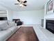 Bright living room with neutral paint, fireplace, plush carpet, and leather sofas; ideal for relaxation and gatherings at 404 After Glow Smt, Canton, GA 30114