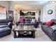 Open concept living room boasts hardwood floors and a large leather sofa and chair set at 404 After Glow Smt, Canton, GA 30114