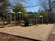 Community playground with wood chip flooring and climbing structures offers children a safe and fun play area at 404 After Glow Smt, Canton, GA 30114