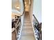 Carpeted staircase with wood handrails leading to the second floor of the home at 404 After Glow Smt, Canton, GA 30114