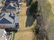 Aerial view of a private backyard with a fence, patio, and green space, bordered by mature trees at 5325 Davenport Mnr, Cumming, GA 30041