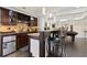 A bar area with dark wood cabinets, granite countertops, a wine rack, pendant lights, and bar seating at 5325 Davenport Mnr, Cumming, GA 30041