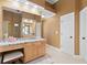 Bright bathroom featuring a vanity, mirror, lots of counterspace, and white doors at 5325 Davenport Mnr, Cumming, GA 30041