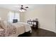 Bedroom featuring a cozy bed, ceiling fan, and closet for storage in the home at 5325 Davenport Mnr, Cumming, GA 30041