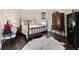 Bright bedroom showcasing a four-poster bed, elegant dresser, and a secure black safe at 5325 Davenport Mnr, Cumming, GA 30041