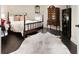 Cozy bedroom featuring a four-poster bed, dark wood floors, and an elegant decorative rug at 5325 Davenport Mnr, Cumming, GA 30041