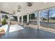 Covered patio offers a herringbone tile floor and a serene view of the backyard at 5325 Davenport Mnr, Cumming, GA 30041
