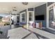 Covered patio with a TV, herringbone tile floor, and furniture at 5325 Davenport Mnr, Cumming, GA 30041