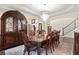 Elegant dining room with a tray ceiling, chandelier, and hardwood floors at 5325 Davenport Mnr, Cumming, GA 30041