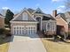 Charming brick home with a two-car garage and well-manicured landscaping, perfect for curb appeal at 5325 Davenport Mnr, Cumming, GA 30041
