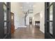 Grand foyer with a curved staircase, hardwood floors, and soaring ceilings at 5325 Davenport Mnr, Cumming, GA 30041