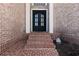 Elegant brick entryway with a classic black double door and a welcoming ambiance at 5325 Davenport Mnr, Cumming, GA 30041