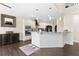 Open kitchen with a white island, granite counters, and stainless steel appliances at 5325 Davenport Mnr, Cumming, GA 30041