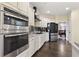 Well-equipped kitchen with stainless steel appliances, granite countertops, and sleek cabinetry at 5325 Davenport Mnr, Cumming, GA 30041