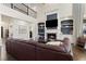 Spacious living room with a fireplace, built-in shelves, and a cozy leather sofa at 5325 Davenport Mnr, Cumming, GA 30041