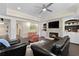 A basement living room featuring a fireplace, built-in shelving, and comfortable seating furniture at 5325 Davenport Mnr, Cumming, GA 30041