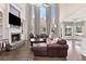 Inviting living room with fireplace and large windows, filling the space with natural light at 5325 Davenport Mnr, Cumming, GA 30041
