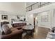 Open concept living area with dark hardwood floors and a view of the kitchen at 5325 Davenport Mnr, Cumming, GA 30041