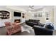 A basement living room features a stone fireplace, built-in shelving, and a comfortable seating arrangement at 5325 Davenport Mnr, Cumming, GA 30041