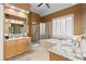 Bright bathroom features granite countertops, dual sinks, a soaking tub, and a glass enclosed shower at 5325 Davenport Mnr, Cumming, GA 30041