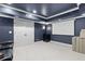 Finished basement space featuring dark navy walls, plush carpet, and a projector screen at 5325 Davenport Mnr, Cumming, GA 30041