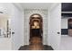 An arched stone entrance leads to a wine cellar with a black iron gate and extensive wine storage at 5325 Davenport Mnr, Cumming, GA 30041