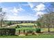 Backyard view with a sitting bench overlooking a golf course at 1004 Windermere Xing, Cumming, GA 30041