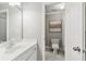 This bathroom features a white marble floor, framed mirror, and connects to a bright, tiled standing shower at 1004 Windermere Xing, Cumming, GA 30041