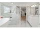 Bright bathroom features marble floors, large soaking tub, and a glass enclosed shower with luxe heated towel rack at 1004 Windermere Xing, Cumming, GA 30041