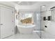 Luxurious bathroom with marble accents, a freestanding tub, and glass shower for a modern, elegant design at 1004 Windermere Xing, Cumming, GA 30041
