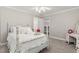 This spacious bedroom features a fan, large windows, and access to a bright, tiled en suite bathroom at 1004 Windermere Xing, Cumming, GA 30041
