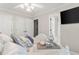 This bedroom offers neutral decor and contains three closets, ceiling fan, and en suite bathroom at 1004 Windermere Xing, Cumming, GA 30041