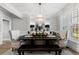 Elegant dining room showcasing a modern chandelier, stylish furnishings, and large windows at 1004 Windermere Xing, Cumming, GA 30041