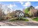 Beautiful home exterior with a circular driveway and mature landscaping, offering great curb appeal at 1004 Windermere Xing, Cumming, GA 30041