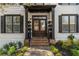 Inviting front entrance featuring double doors, brick steps, and manicured landscaping at 1004 Windermere Xing, Cumming, GA 30041
