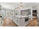 Spacious kitchen island, hardwood floors, and open floor plan to the living and dining spaces at 1004 Windermere Xing, Cumming, GA 30041