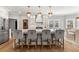 Modern kitchen island with bar stool seating, pendant lights, and stainless steel appliances at 1004 Windermere Xing, Cumming, GA 30041