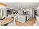 Open-concept kitchen featuring white cabinetry, marble counters, stainless appliances and views to the living room at 1004 Windermere Xing, Cumming, GA 30041