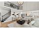 Expansive living room with soaring ceilings, fireplace, and an open floor plan to the gourmet kitchen at 1004 Windermere Xing, Cumming, GA 30041
