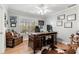 Bright office area features hardwood floors, a large desk, and shelving for personal items at 1004 Windermere Xing, Cumming, GA 30041