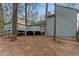 View of a spacious backyard featuring a charming deck surrounded by lush trees, perfect for relaxation and outdoor gatherings at 135 S Falcon Blf, Alpharetta, GA 30022
