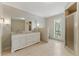 Spacious bathroom with double vanity, granite counters, and a glass shower with natural light at 135 S Falcon Blf, Alpharetta, GA 30022